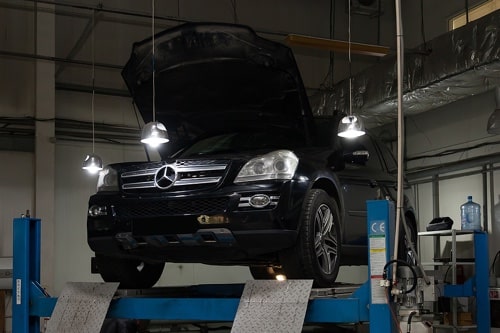Bock Auto, Is It Time for Maintenance on Your Mercedes? Let Bock Auto Help: Black Mercedes SUV pictured on lift in shop
