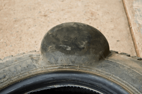 Why Tires Bulges Spell Trouble – and What to Do About It with Bock Auto in Amagansett, NY closeup image of bulge in tire that came in shop