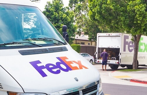 Spring Fleet Services in Amagansett, NY by Bock Auto. Image of FedEx trucks and delivery man.