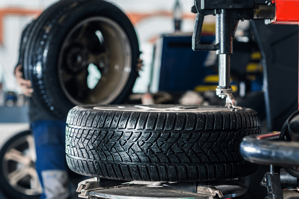spring car maintenance, auto repair in Amagansett, NY at Bock Auto. Tire installation in progress at an auto repair shop.